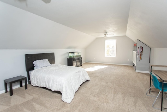 carpeted bedroom featuring ceiling fan and vaulted ceiling