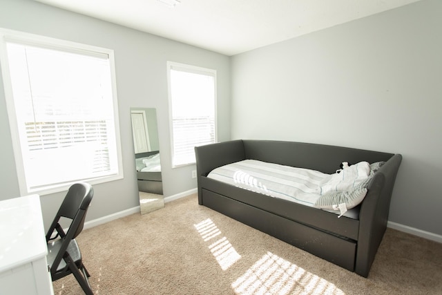 bedroom featuring light colored carpet