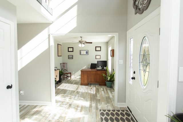 foyer entrance featuring light hardwood / wood-style flooring, a wealth of natural light, and ceiling fan