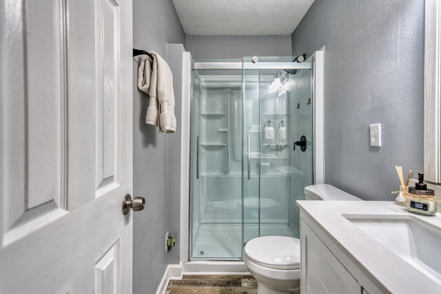 270 River Chase Rd, Allensville, KY 42204 - bathroom with toilet, a stall shower, a textured ceiling, vanity, and wood finished floors