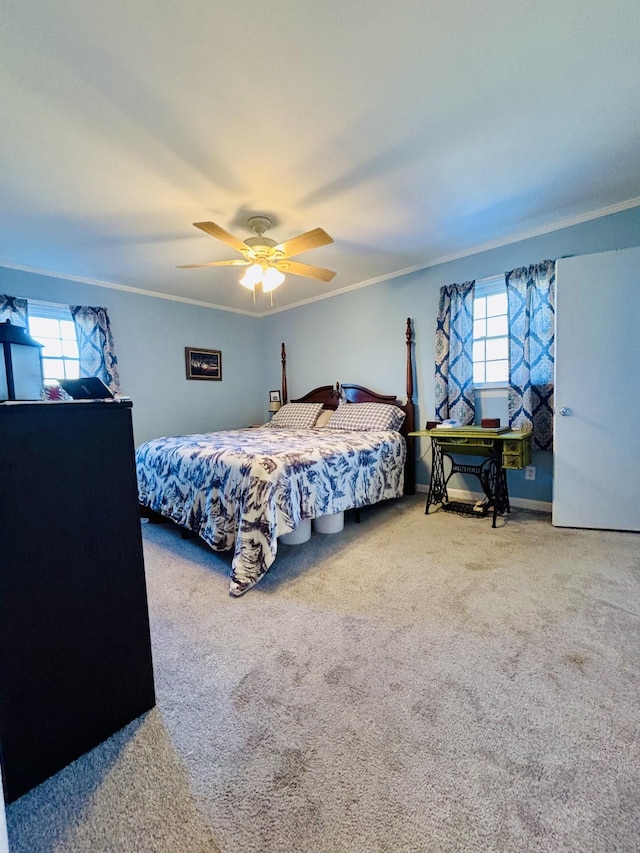 carpeted bedroom with ornamental molding and ceiling fan