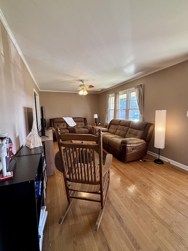 living room featuring crown molding, ceiling fan, and light hardwood / wood-style floors