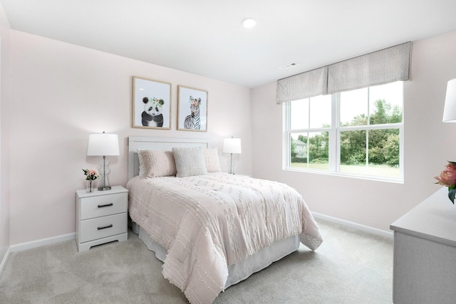 bedroom featuring light colored carpet