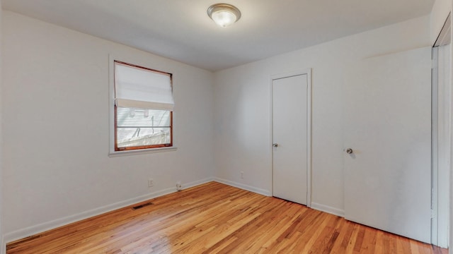 unfurnished bedroom with a closet and light wood-type flooring