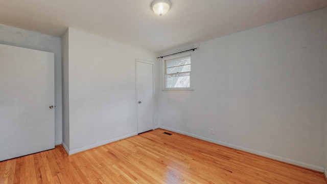 spare room featuring light wood-type flooring