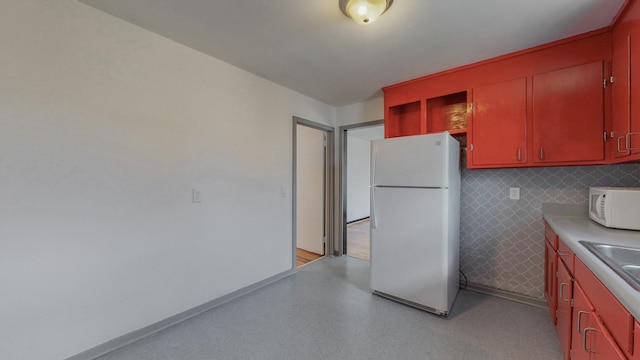 kitchen featuring white appliances and sink