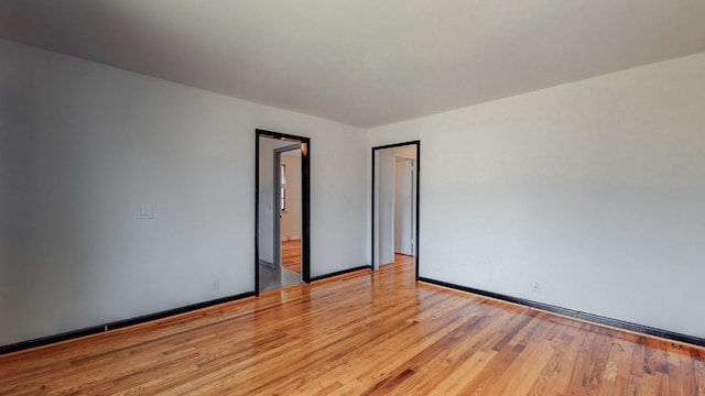 unfurnished room with light wood-type flooring