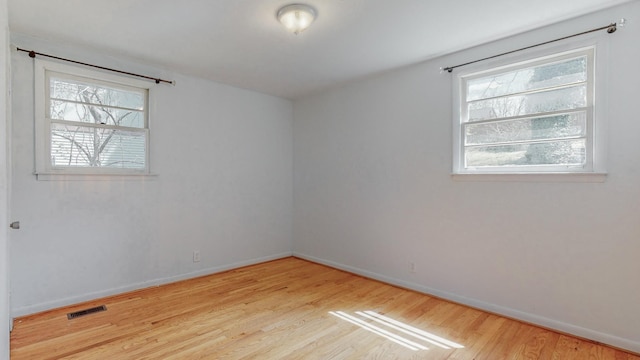 spare room with light hardwood / wood-style flooring