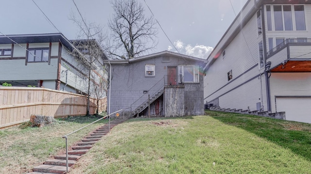 rear view of house featuring a lawn