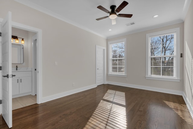 empty room featuring dark wood-type flooring, crown molding, and ceiling fan