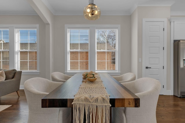 dining room featuring plenty of natural light and crown molding