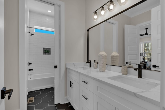 bathroom with ceiling fan, vanity, tile patterned flooring, and tiled shower / bath