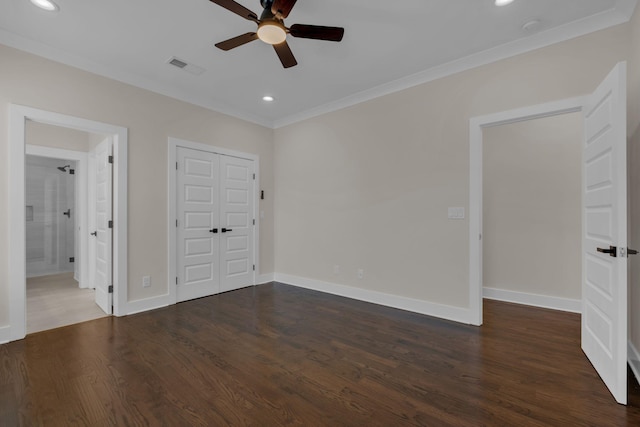 unfurnished bedroom featuring ceiling fan, dark wood-type flooring, and crown molding