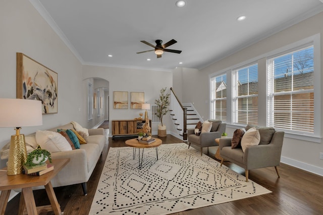 living room featuring ceiling fan, ornamental molding, and dark hardwood / wood-style floors