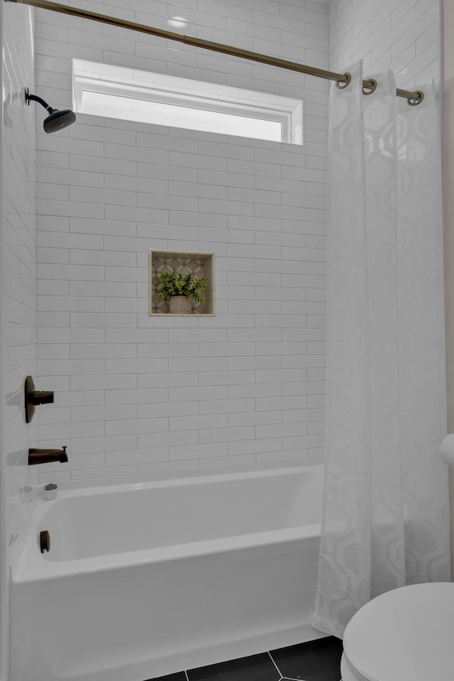 bathroom with toilet, tile patterned flooring, a wealth of natural light, and shower / bath combination with curtain