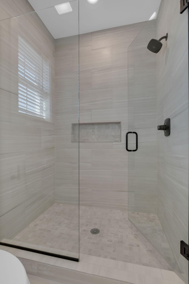 bathroom with walk in shower and toilet