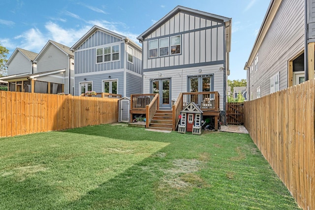 back of house with a yard and french doors