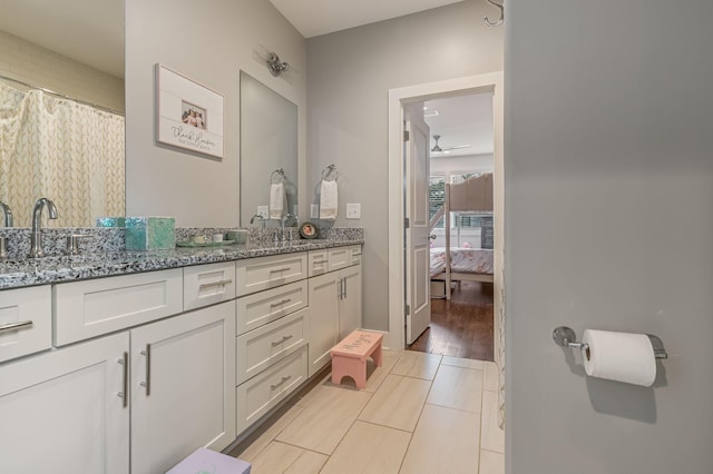 bathroom with tile patterned flooring, vanity, and ceiling fan