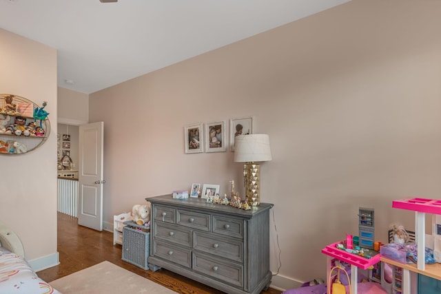 bedroom with dark hardwood / wood-style flooring