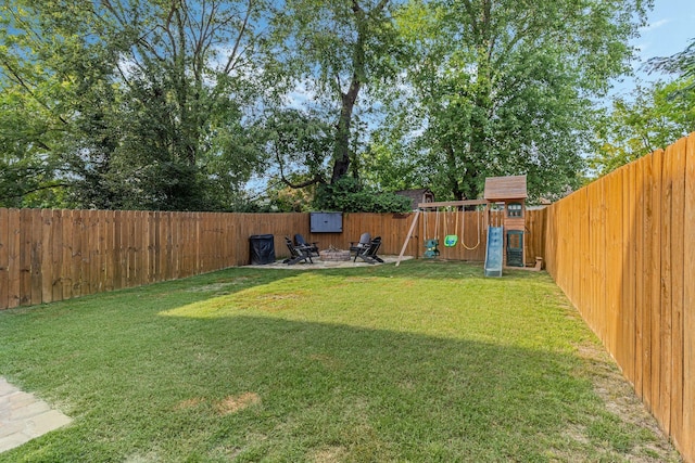 view of yard with a playground and a patio