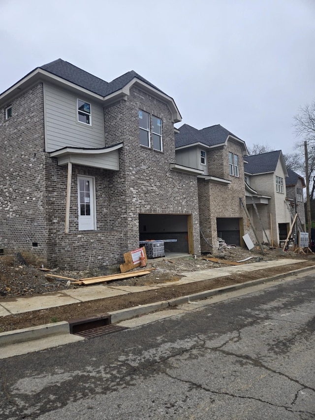 view of side of property with an attached garage, central air condition unit, and brick siding