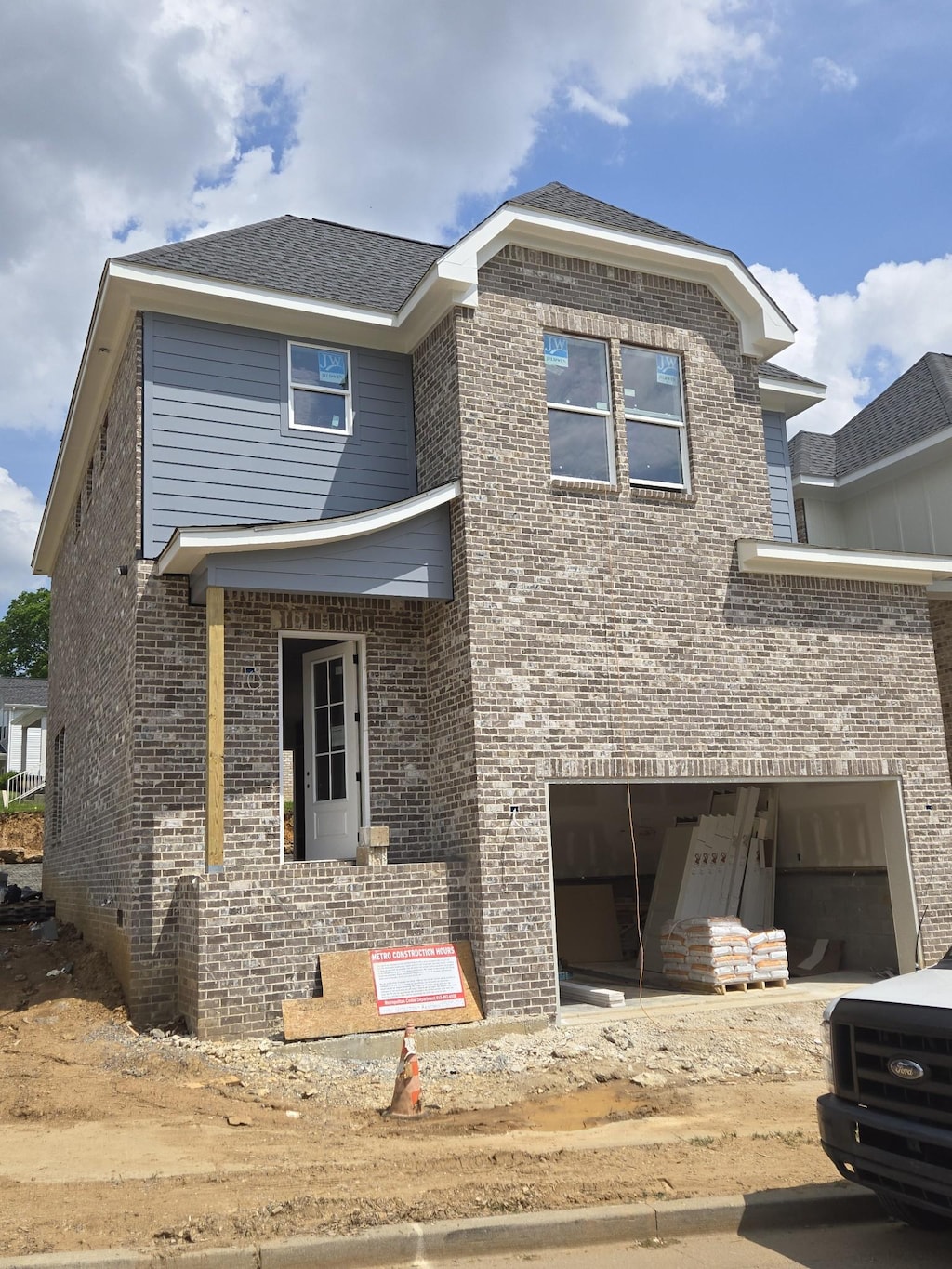 view of front facade featuring brick siding and an attached garage
