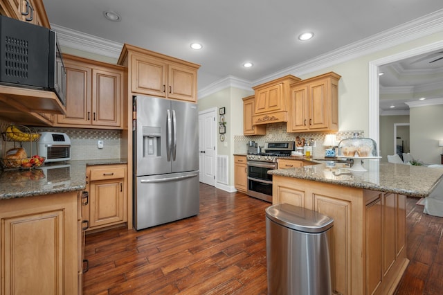 kitchen featuring kitchen peninsula, stainless steel appliances, dark stone counters, and ornamental molding