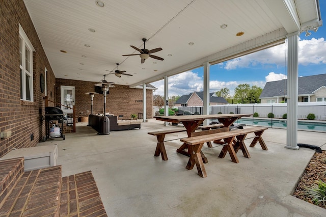 view of patio with a fenced in pool, grilling area, ceiling fan, and an outdoor hangout area