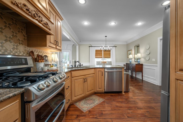 kitchen featuring pendant lighting, crown molding, sink, appliances with stainless steel finishes, and a chandelier