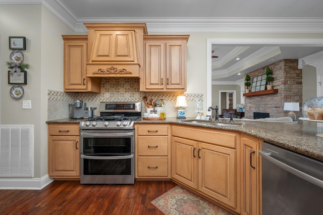 kitchen with crown molding, custom range hood, sink, and appliances with stainless steel finishes