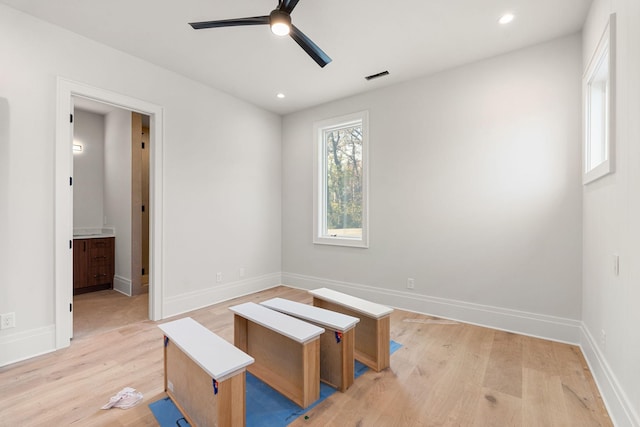 interior space with ceiling fan, ensuite bathroom, and light hardwood / wood-style floors