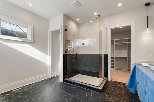 bathroom with a shower with door