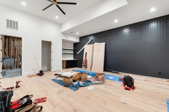 living room with ceiling fan and light hardwood / wood-style floors