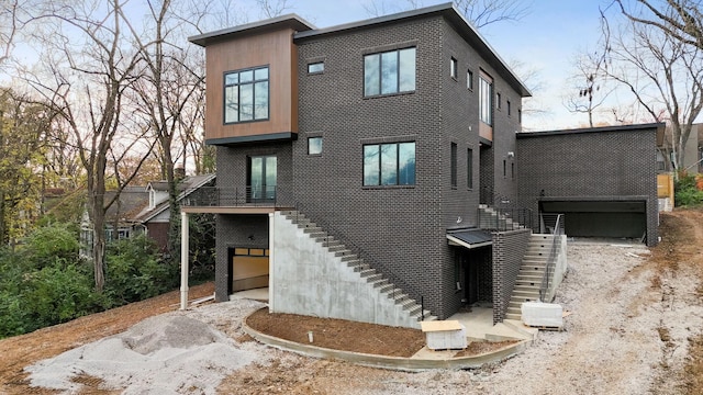 rear view of property with a garage