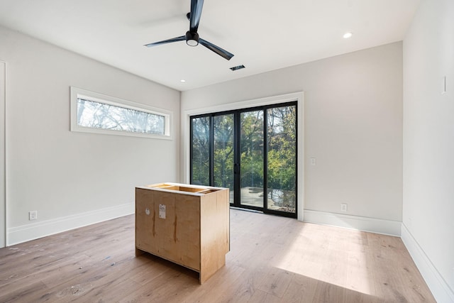 interior space with hardwood / wood-style flooring and ceiling fan