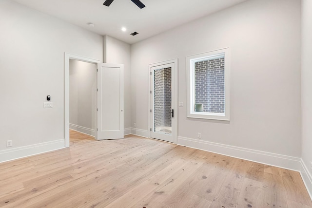 unfurnished room with light wood-type flooring and ceiling fan