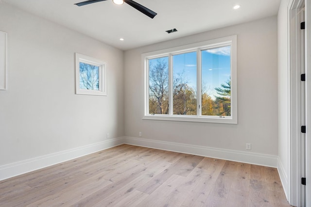 spare room with ceiling fan and light wood-type flooring