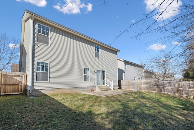 rear view of property with a yard and a patio