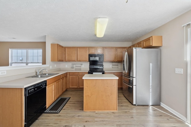 kitchen with a center island, sink, light hardwood / wood-style flooring, and black appliances