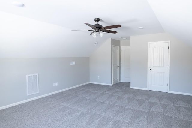 bonus room featuring dark colored carpet, ceiling fan, and vaulted ceiling