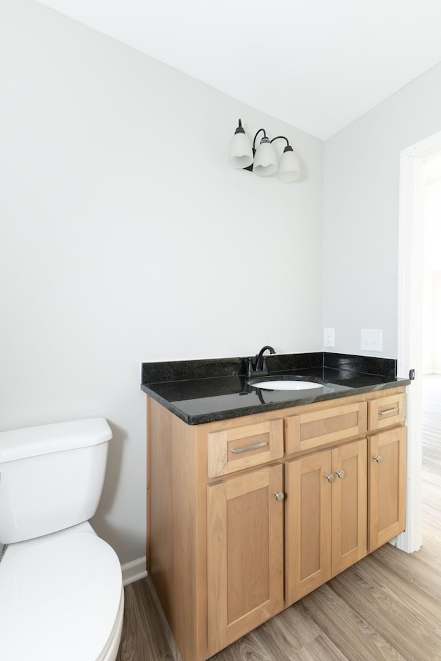 bathroom featuring hardwood / wood-style floors, vanity, and toilet