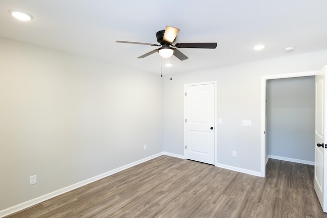 empty room featuring hardwood / wood-style floors and ceiling fan