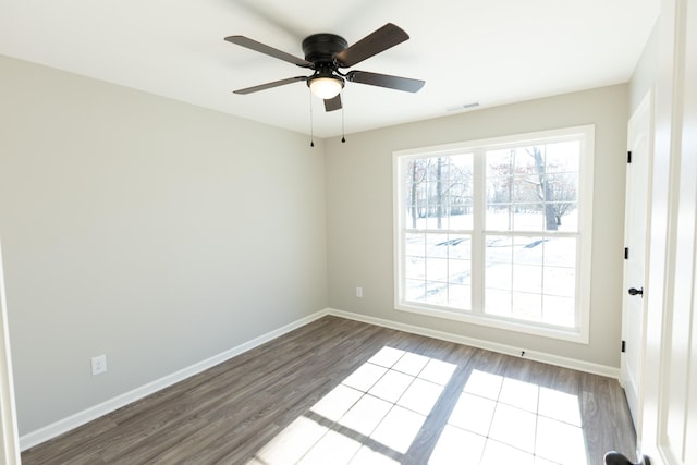 empty room with ceiling fan and hardwood / wood-style floors