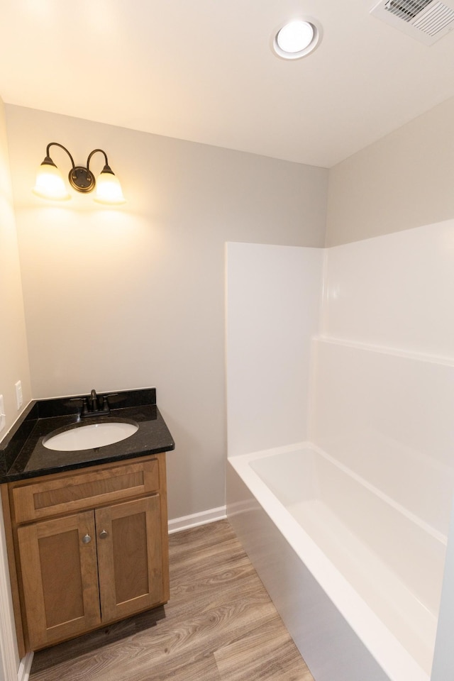 bathroom with hardwood / wood-style floors and vanity