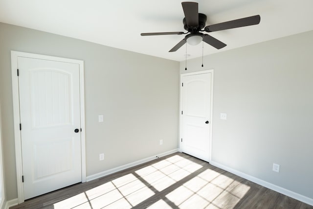 empty room featuring ceiling fan and hardwood / wood-style flooring