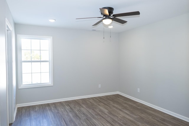 unfurnished room featuring ceiling fan and dark hardwood / wood-style flooring