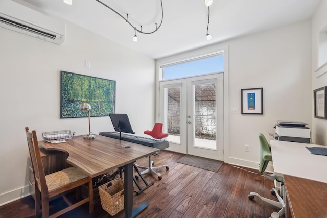 office space with french doors, rail lighting, dark hardwood / wood-style floors, and a wall mounted air conditioner