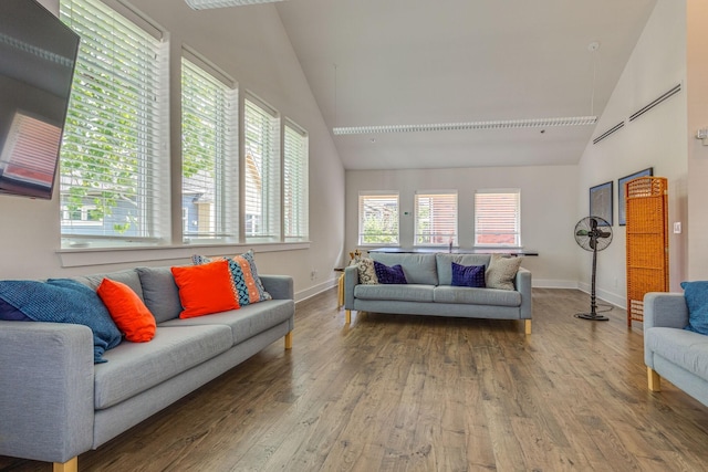 living room with high vaulted ceiling and hardwood / wood-style flooring