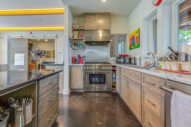 kitchen featuring high end stove, sink, and extractor fan