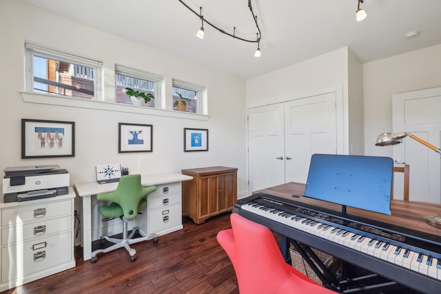 office space with dark wood-type flooring and track lighting